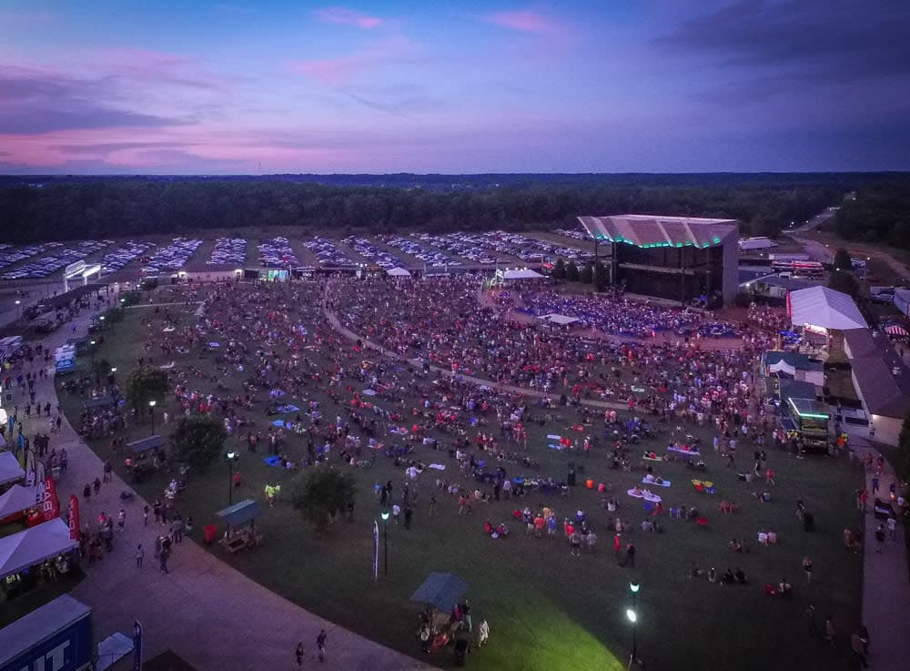 Crowd on the lawn of the CCNB Amphitheater at dusk